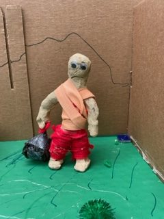 The person is made out of clay and toothpicks.  I took alot of tooth picks and put them together with tape then I put clay over it.  The caly would not stand up by itself, so I made a way to make it stand up.